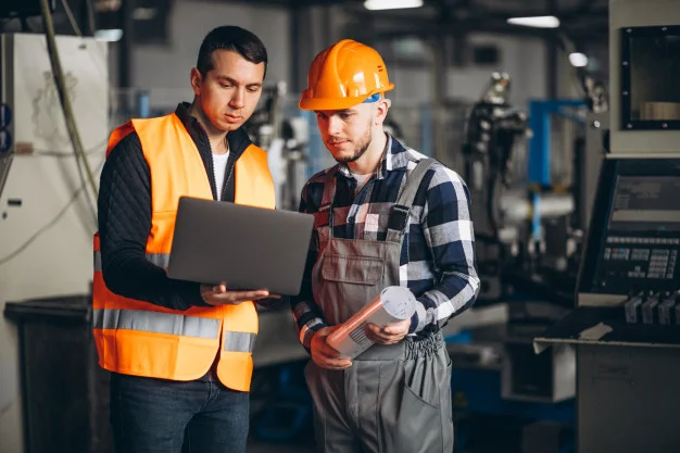 Mechanical engineer graduates working in industrial area.